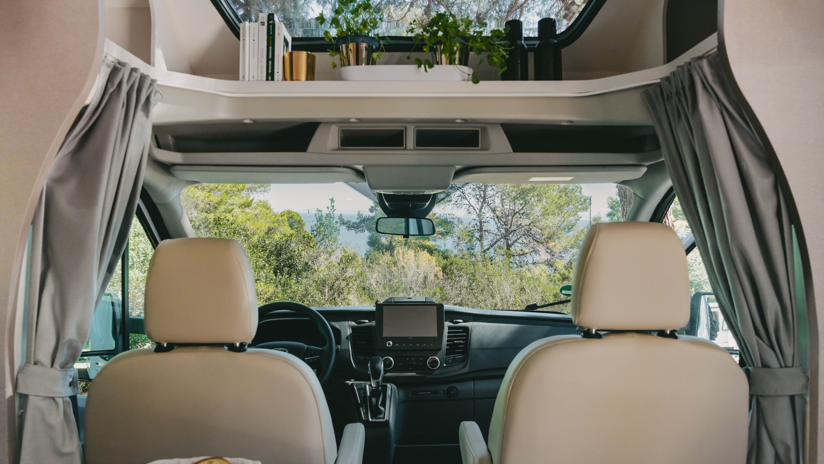 Interior of an Etrusco semi-integrated motorhome on a Ford base with panoramic view and elegant cockpit.