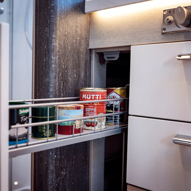 Opened and stocked pharmacy cabinet in the kitchen of the HYMER B-Class MasterLine