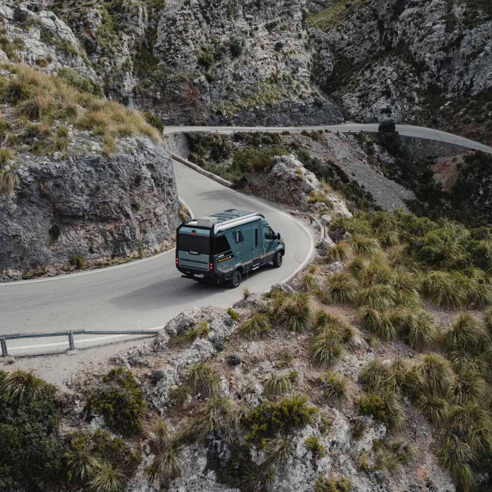 Vue de l'arrière du Venture S, le véhicule descend des routes sinueuses.